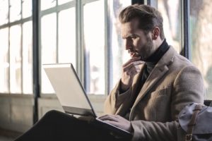 man searching online thinking