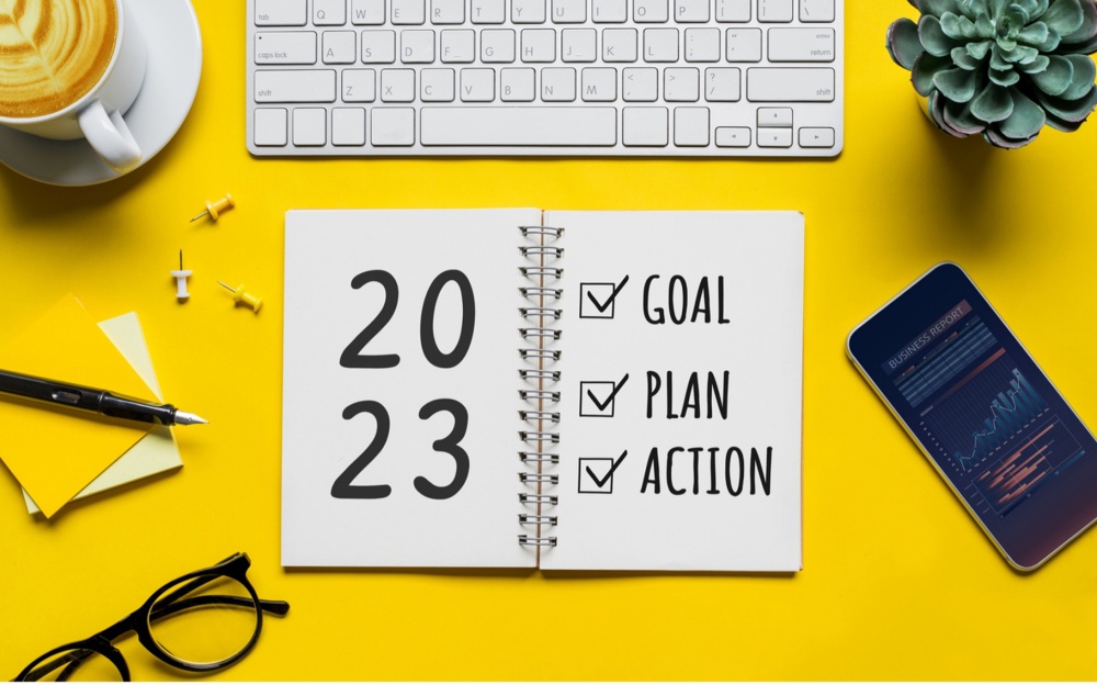open planner for 2023 with checkboxes for goal, plan, and action